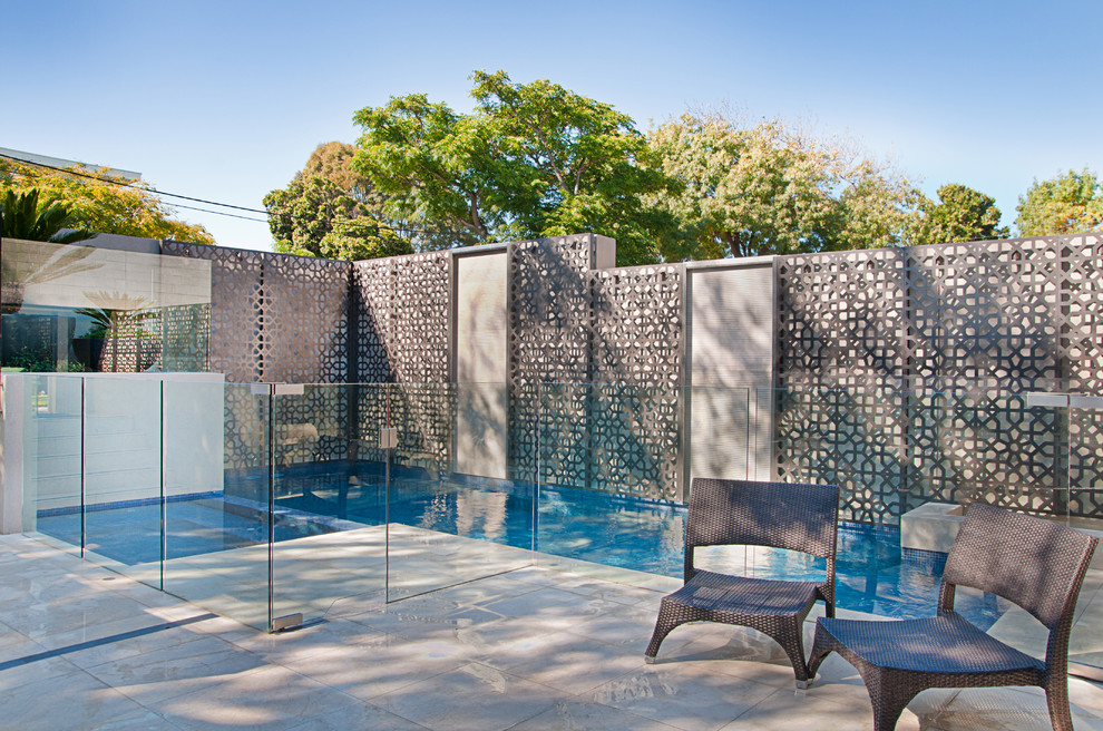 Mid-sized minimalist backyard stone and l-shaped pool photo in Melbourne