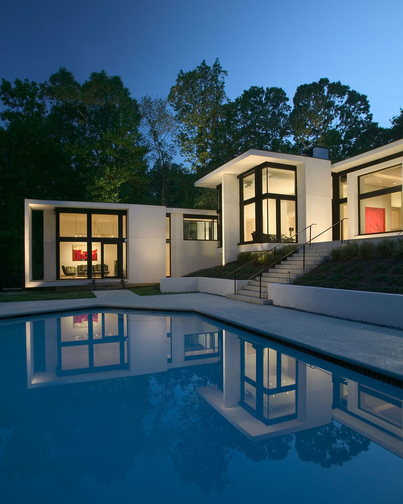 Pool - large modern backyard stamped concrete and custom-shaped lap pool idea in Atlanta