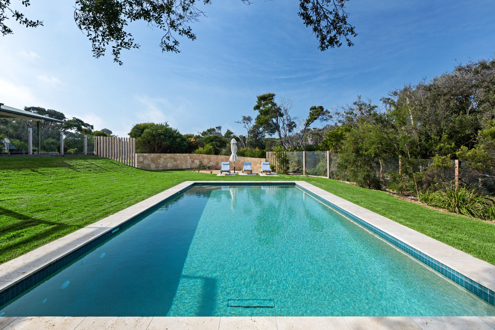 Pool - large traditional backyard stone and rectangular pool idea in Melbourne