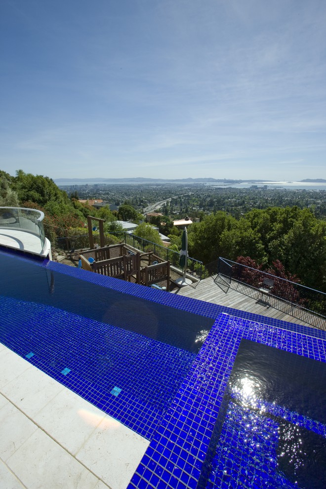 Large trendy backyard tile and rectangular infinity pool fountain photo in San Francisco