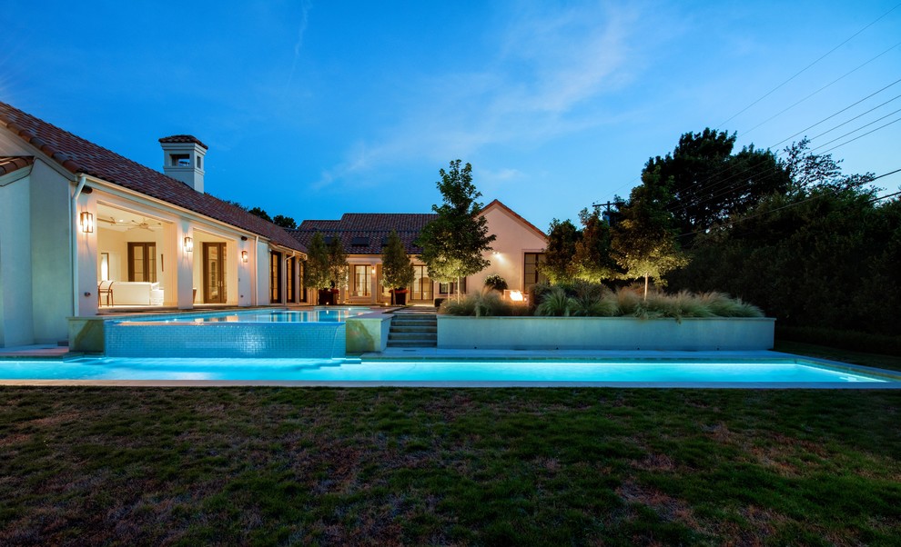 Photo of an expansive modern back rectangular lengths swimming pool in Dallas with a pool house.