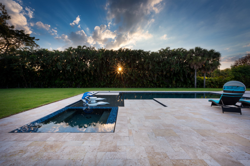 Inspiration for a large modern backyard stone and l-shaped lap hot tub remodel in Miami