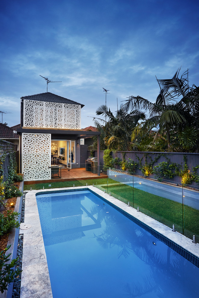 Large trendy backyard rectangular pool photo in Sydney