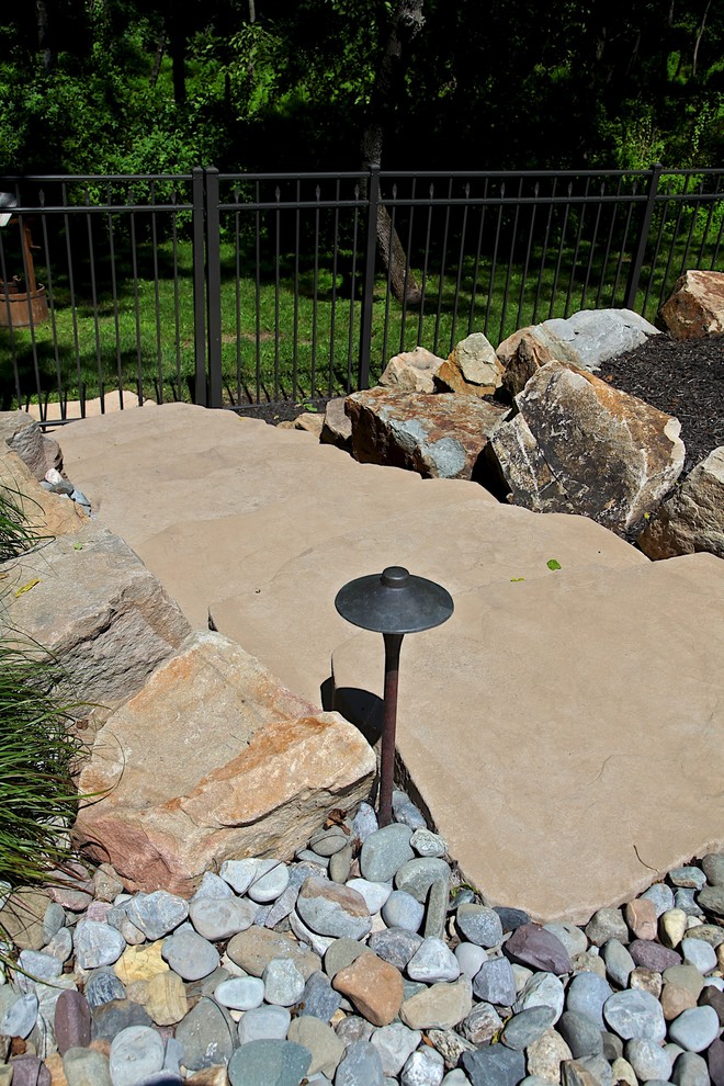 Photo of a medium sized rustic back custom shaped swimming pool in New York with a water feature and brick paving.