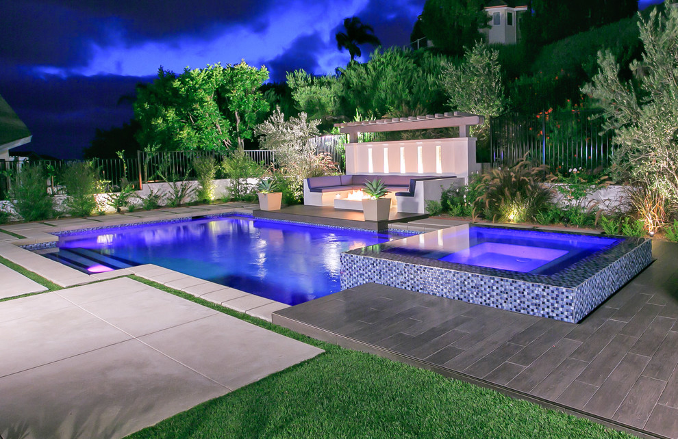 Example of a mid-sized trendy backyard tile and rectangular natural pool fountain design in San Diego