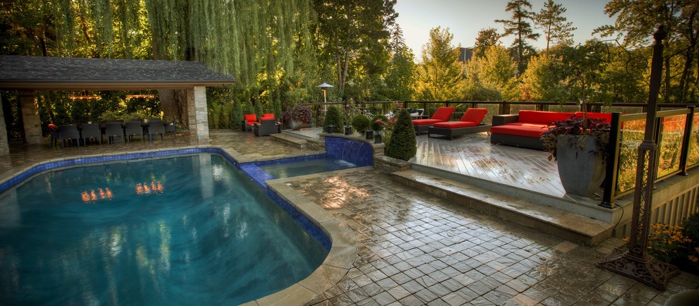 Inspiration for a large classic back rectangular lengths hot tub in Toronto with concrete paving.
