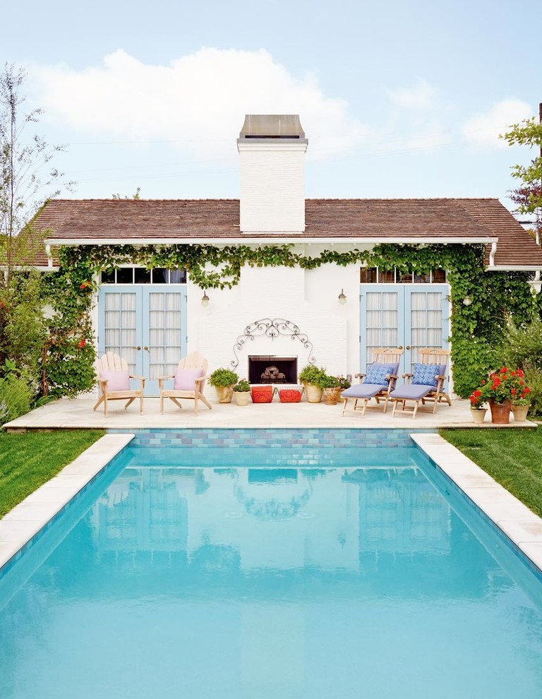 Pool house - mid-sized shabby-chic style backyard concrete paver and rectangular pool house idea in Los Angeles