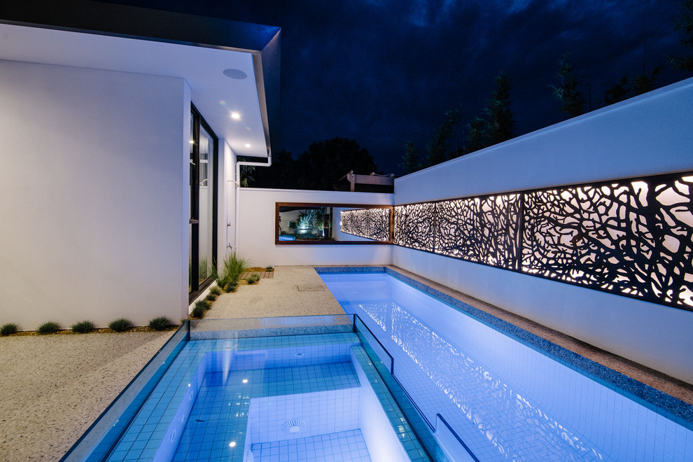 Inspiration for a medium sized contemporary back rectangular lengths hot tub in Adelaide with concrete slabs.