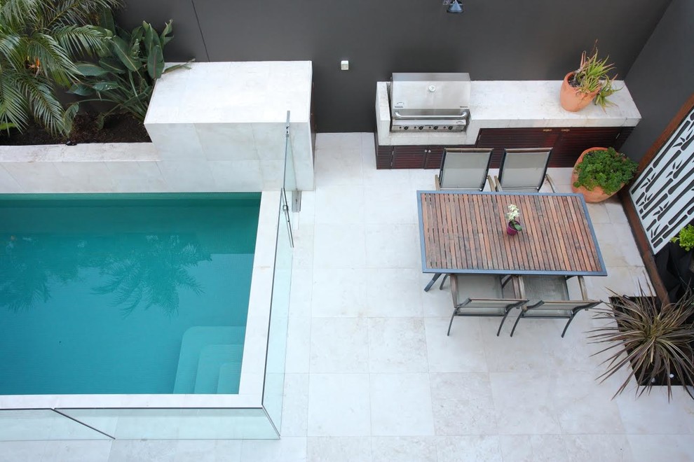 Photo of a medium sized contemporary back rectangular lengths swimming pool in Sydney with a pool house and concrete paving.