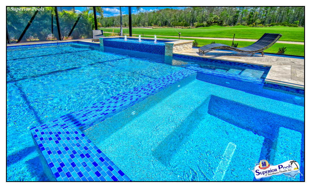 Large island style backyard stone and custom-shaped lap pool fountain photo in Tampa