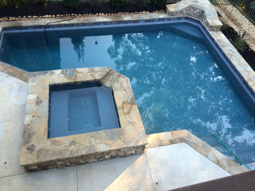 Design ideas for a small classic back custom shaped natural swimming pool in Atlanta with decking.