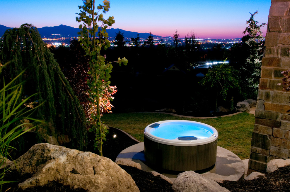 Example of a mid-sized transitional backyard round aboveground hot tub design in Salt Lake City