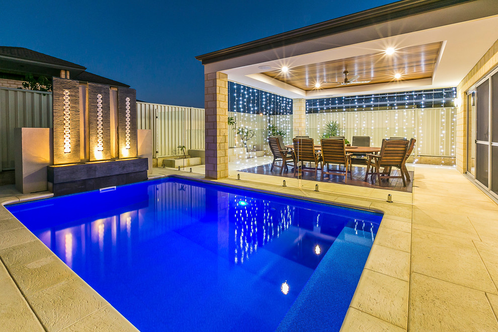 Small trendy backyard stamped concrete and rectangular pool house photo in Perth