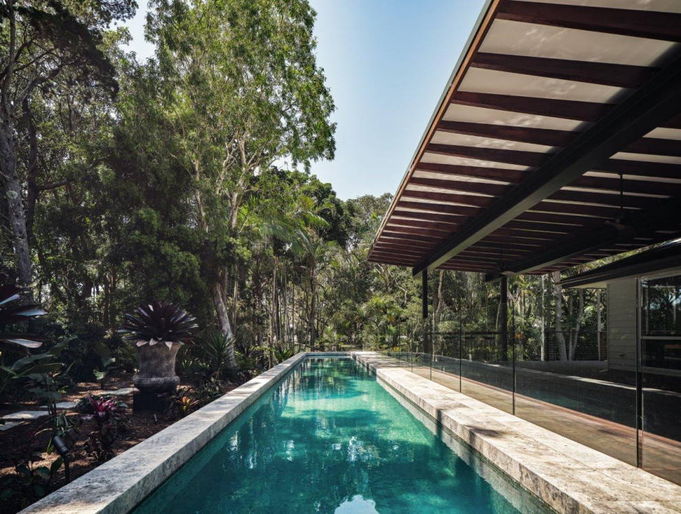 Large world-inspired back rectangular lengths swimming pool in Gold Coast - Tweed with natural stone paving.