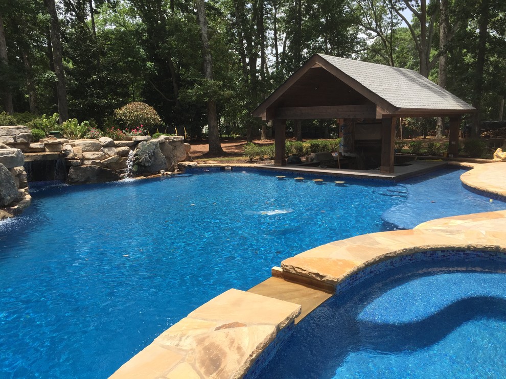 Design ideas for an expansive world-inspired back swimming pool in Atlanta.