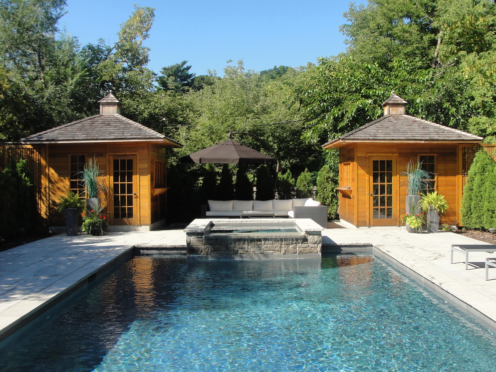 Стильный дизайн: большой прямоугольный бассейн в классическом стиле с домиком у бассейна и покрытием из каменной брусчатки - последний тренд