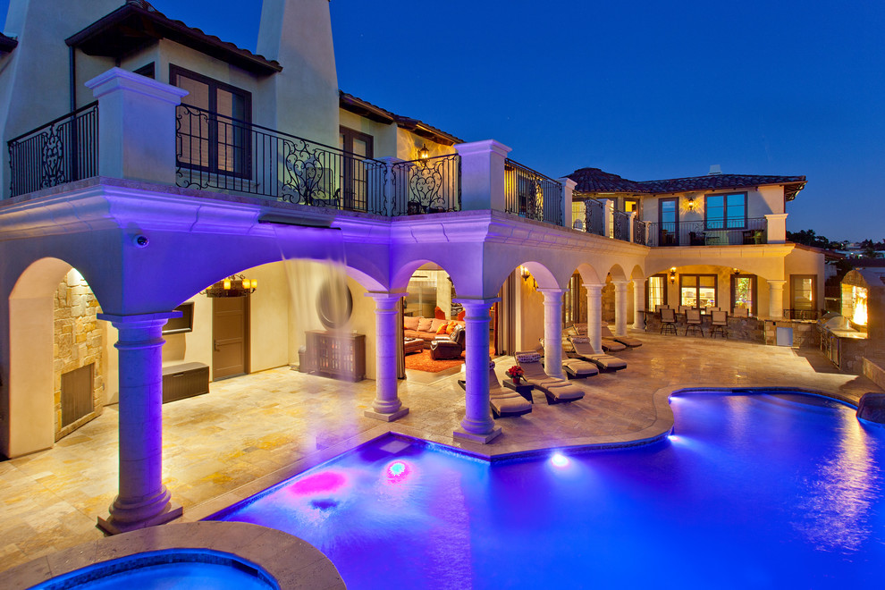 Huge tuscan side yard stone and custom-shaped infinity pool fountain photo in San Diego