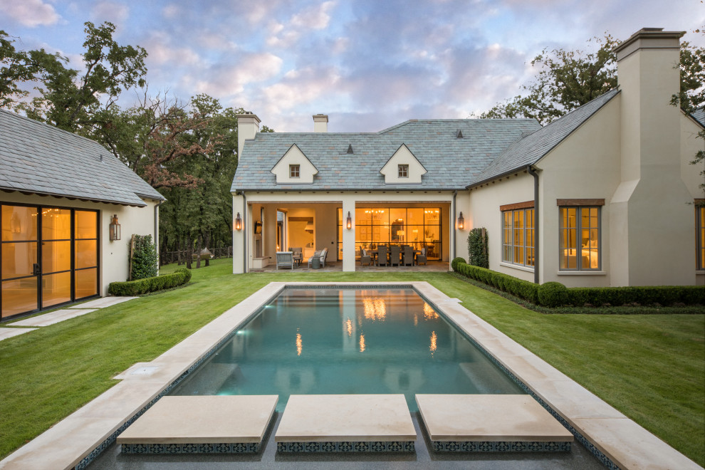 French country rectangular pool photo in Dallas