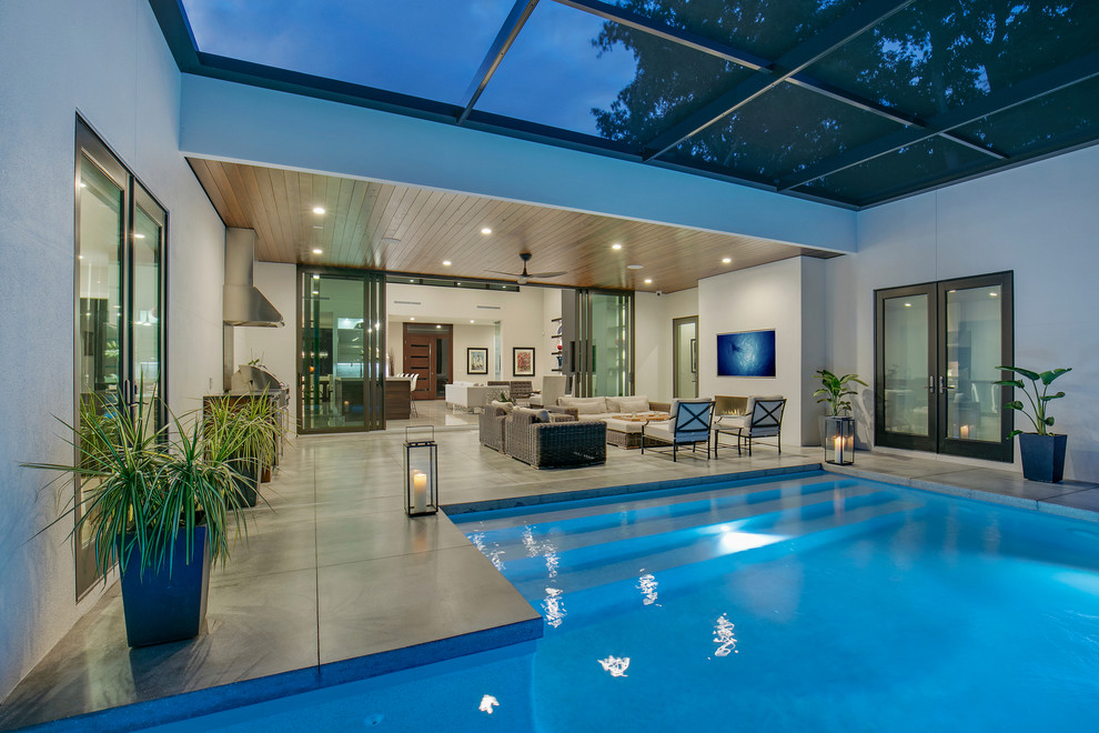 Esempio di una piccola piscina monocorsia minimalista personalizzata dietro casa con fontane e lastre di cemento
