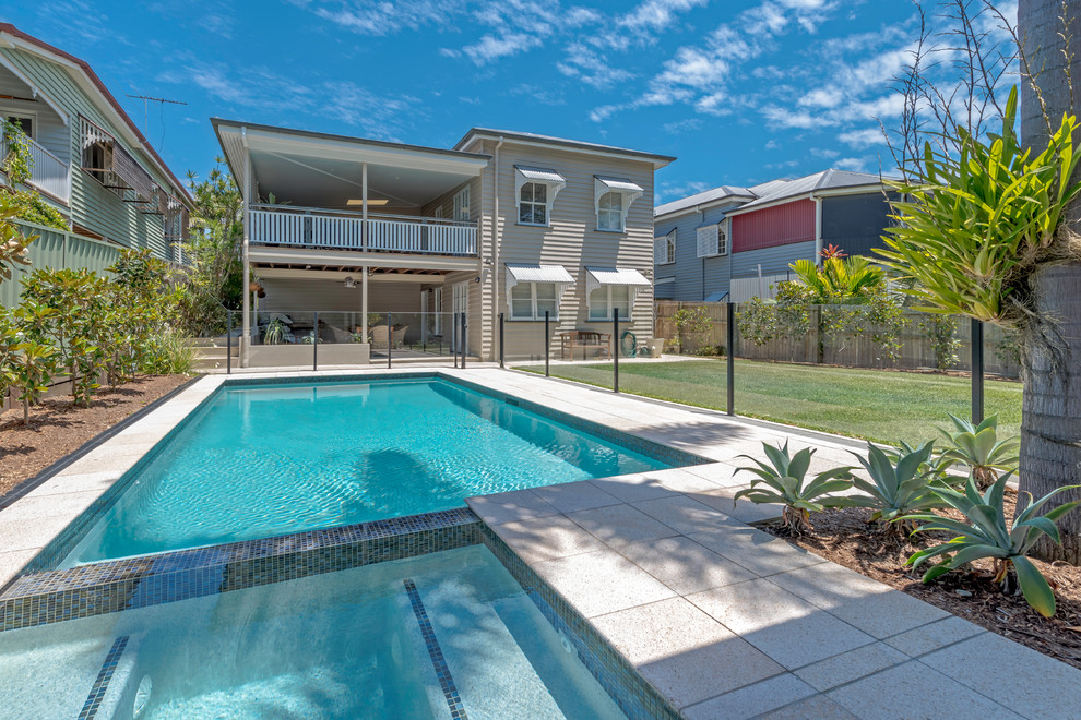 Hot tub - mid-sized tropical backyard stone and rectangular lap hot tub idea in Brisbane