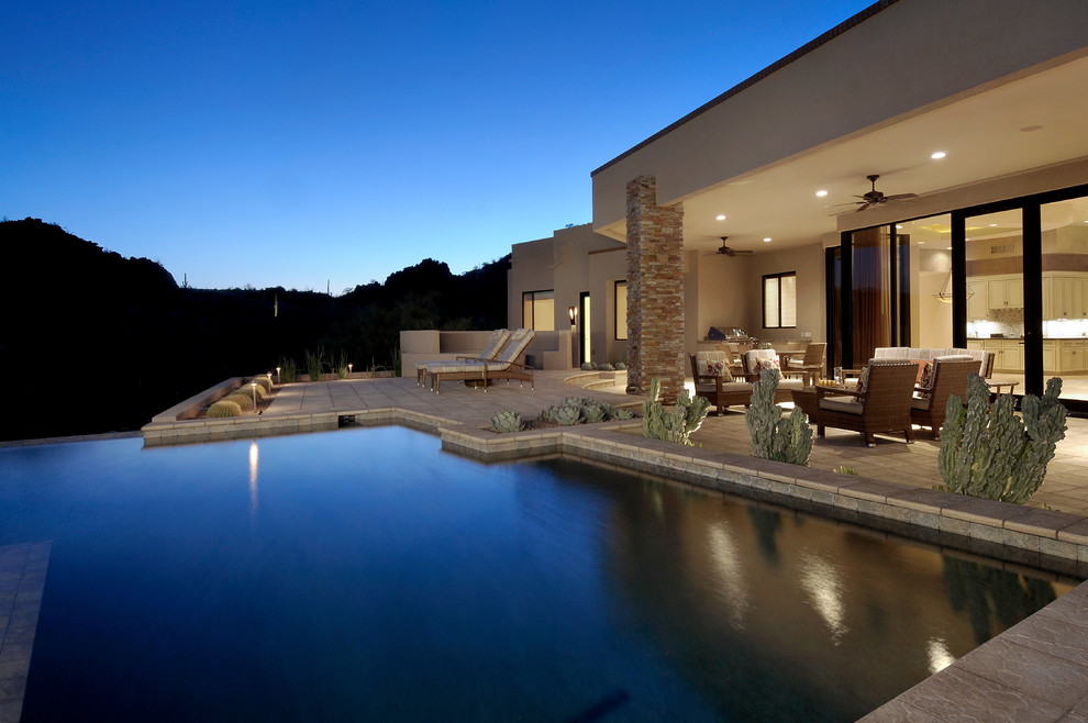 Mediterranean l-shaped swimming pool in Phoenix with a bbq area.