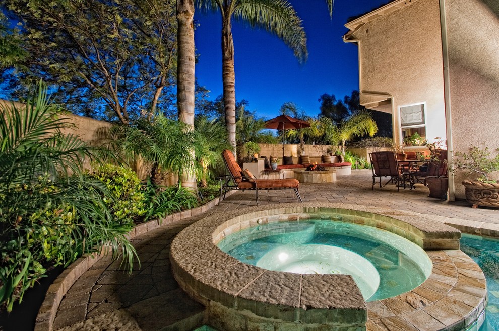 Island style pool photo in San Diego