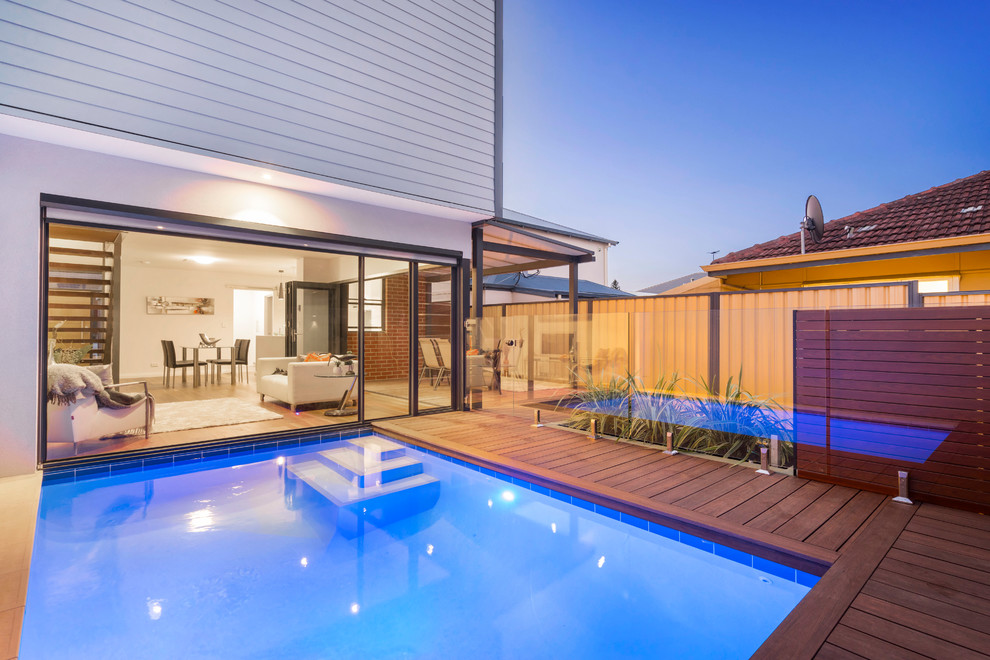 Inspiration for a small contemporary back rectangular natural swimming pool in Perth with a pool house and decking.