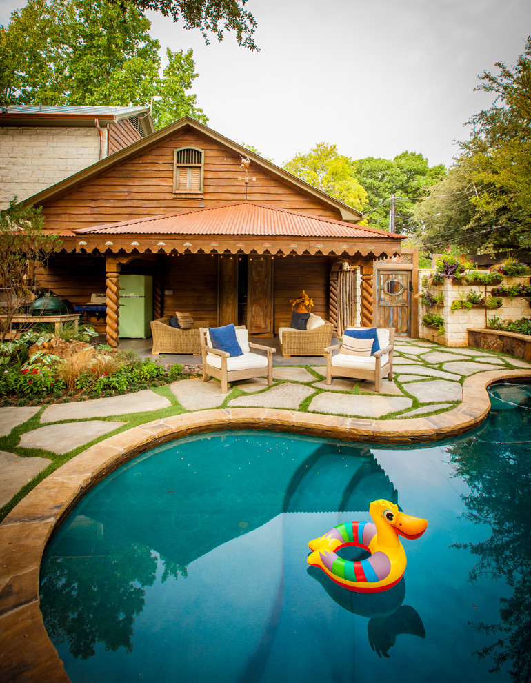 Mountain style kidney-shaped pool photo in Dallas