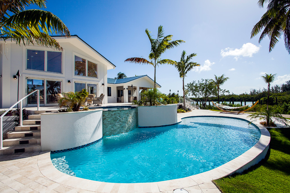 Island style pool photo in Miami