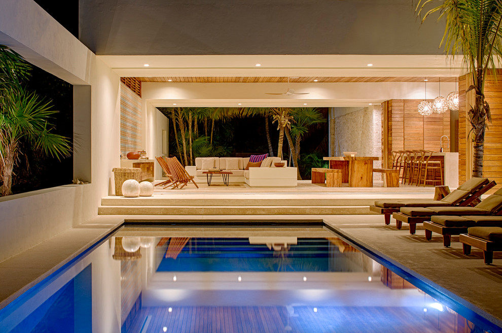 Imagen de piscina tropical grande rectangular en patio trasero