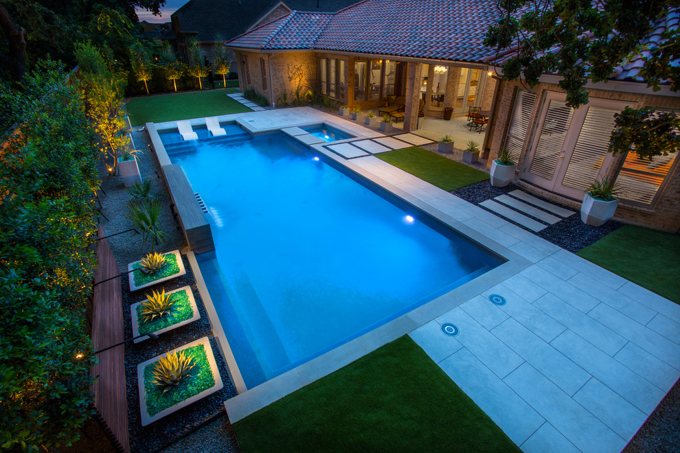 Example of a trendy backyard concrete and rectangular lap pool fountain design in Dallas