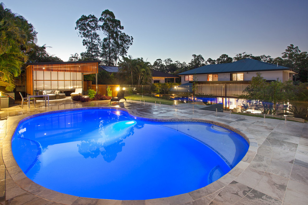 Design ideas for a medium sized contemporary back kidney-shaped swimming pool in Brisbane with tiled flooring.