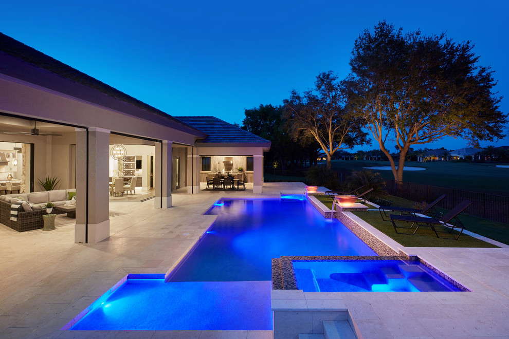 Inspiration for a large contemporary back custom shaped lengths swimming pool in Miami with a pool house and natural stone paving.