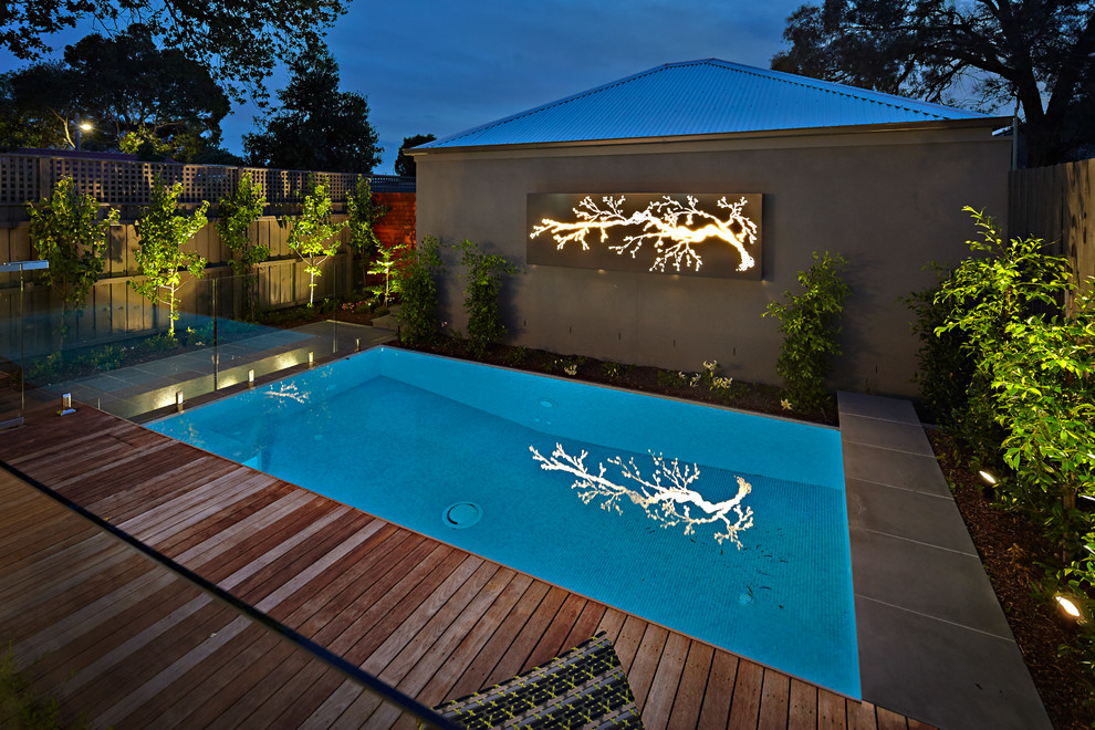 Pool - contemporary backyard stone and rectangular pool idea in Melbourne