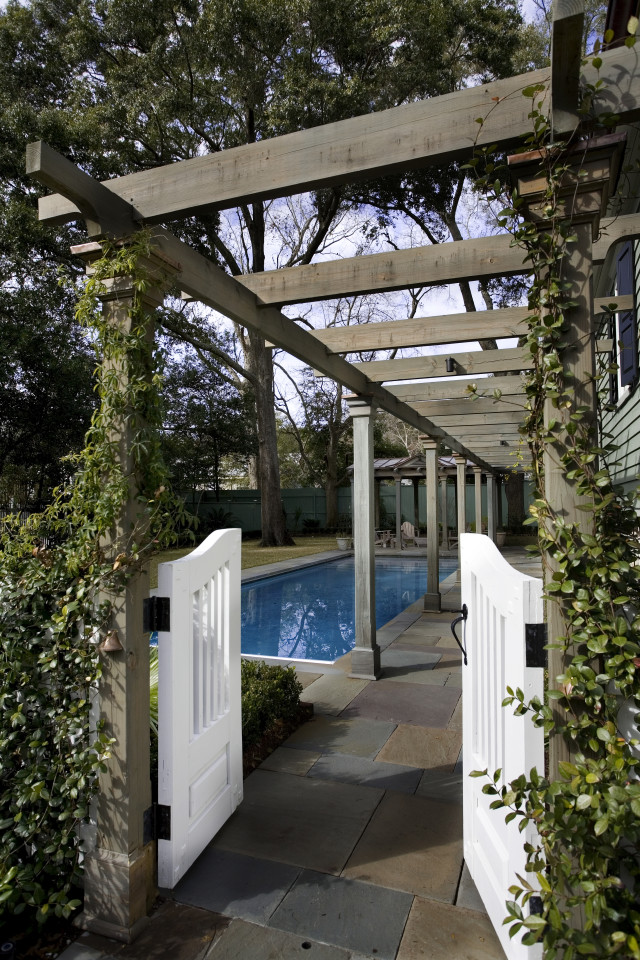 Large elegant backyard concrete paver and custom-shaped natural pool photo in Charleston