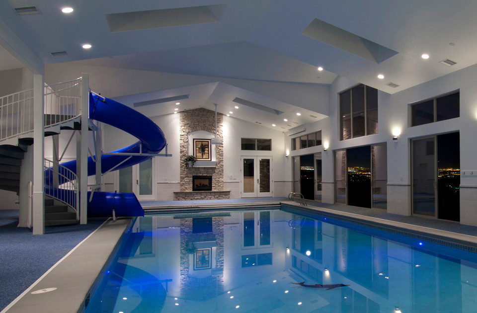 На фото: огромный прямоугольный бассейн в доме в классическом стиле с водной горкой с
