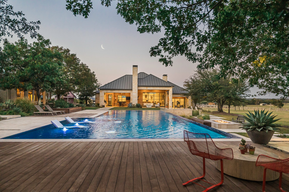 Example of a trendy tile and rectangular pool design in Dallas