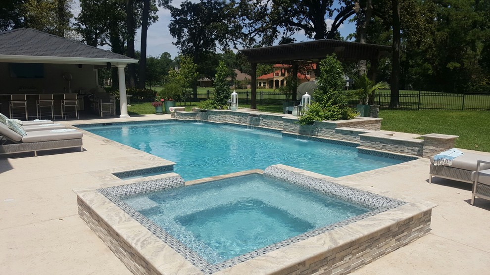 Example of a large classic backyard stone and rectangular pool design in Houston