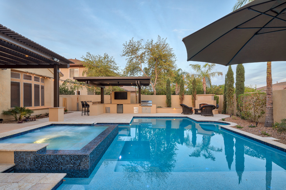 Photo of a contemporary back rectangular swimming pool in Phoenix with brick paving.