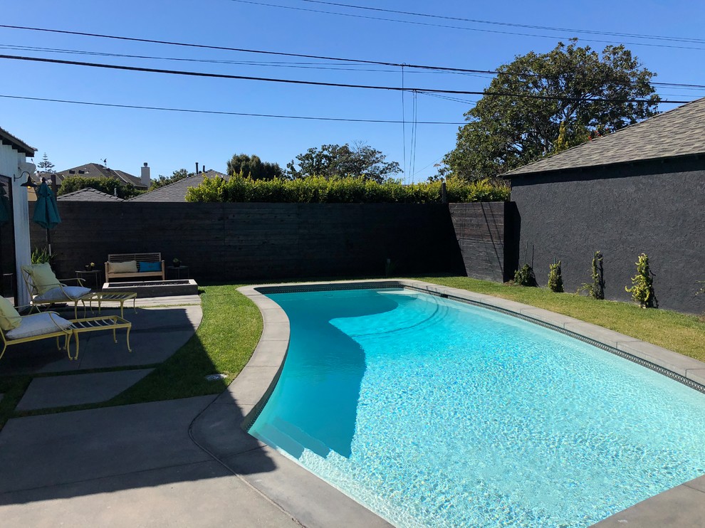 Example of a large cottage backyard concrete and custom-shaped pool design in Los Angeles