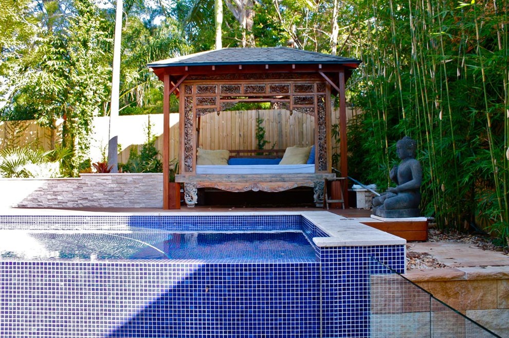 Photo of a large world-inspired back rectangular above ground swimming pool in Sydney with decking.