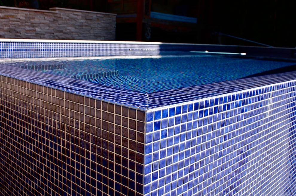 Pool - large backyard rectangular aboveground pool idea in Sydney with decking