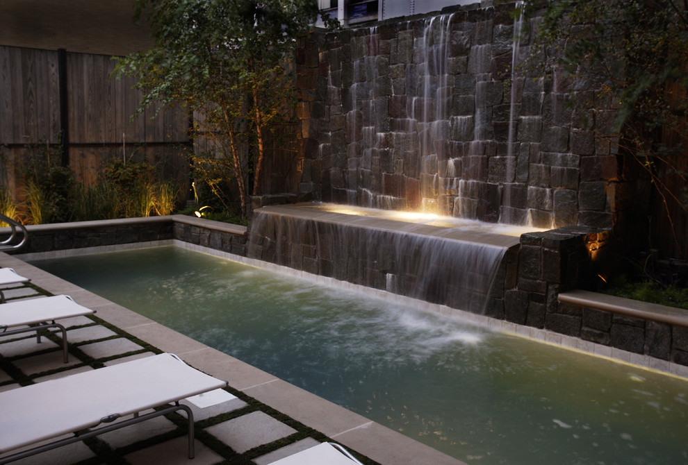 Inspiration for a small modern rectangular lengths hot tub in Chicago with natural stone paving and a shelter.