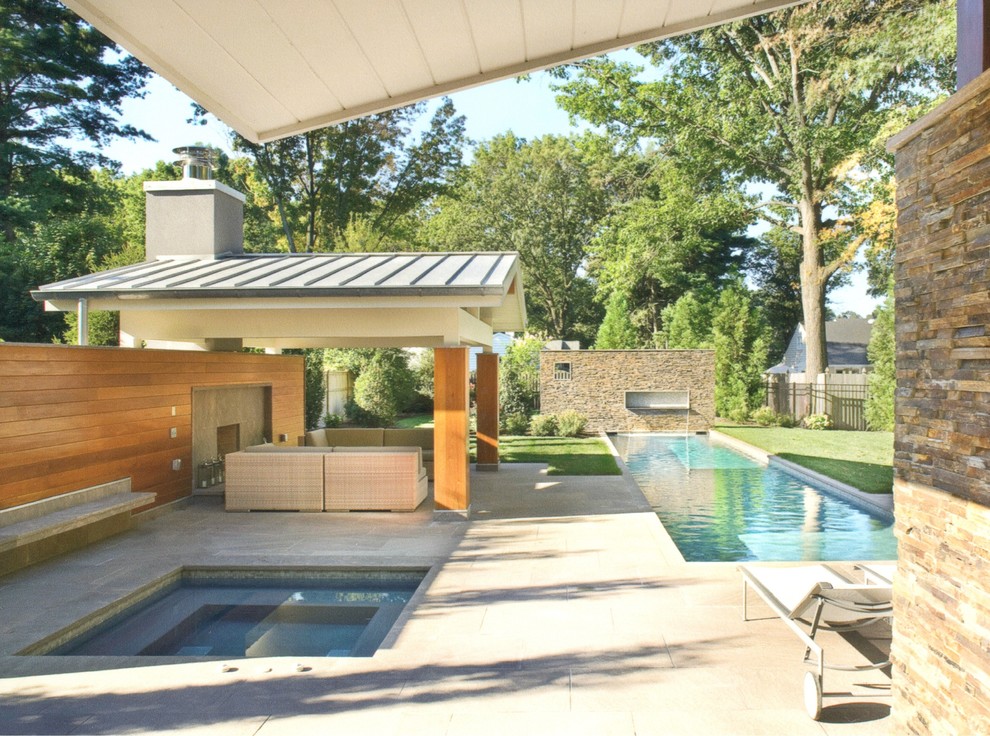 Inspiration for a large contemporary back rectangular lengths swimming pool in Philadelphia with a pool house and concrete paving.