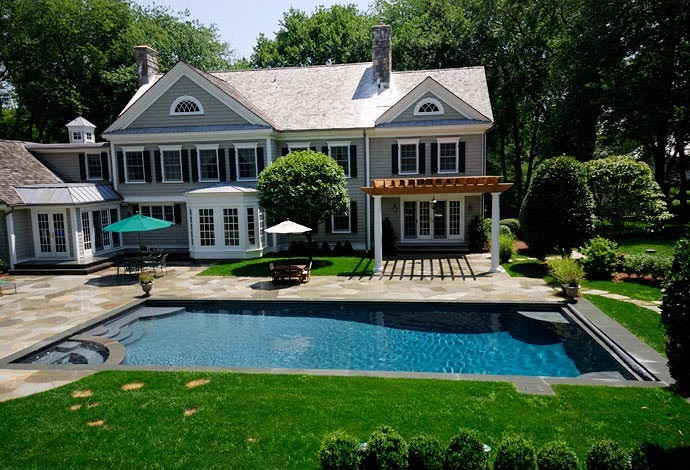 Example of a classic stone and rectangular pool design in New York