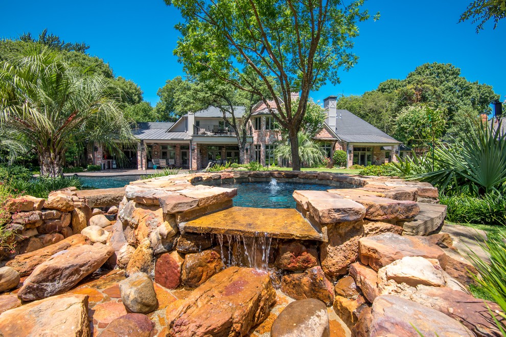 Elegant backyard pool house photo in Dallas