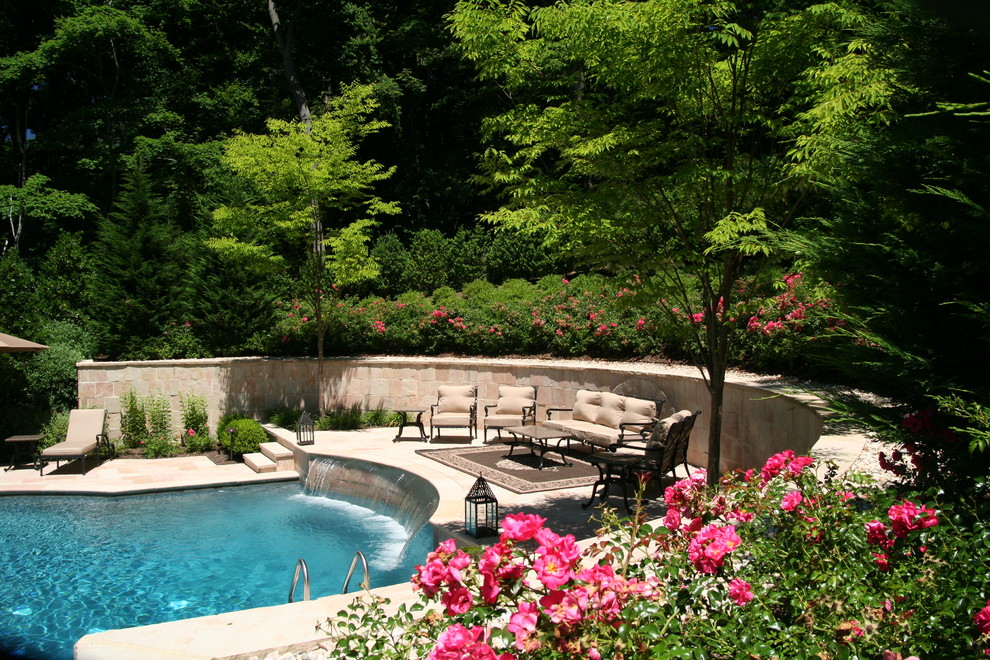 Inspiration for a classic back custom shaped swimming pool in New York with a water feature and natural stone paving.