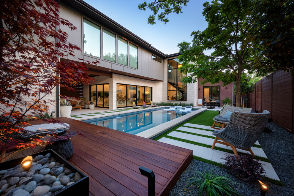 Mittelgroßer Moderner Pool hinter dem Haus in rechteckiger Form mit Natursteinplatten in Dallas