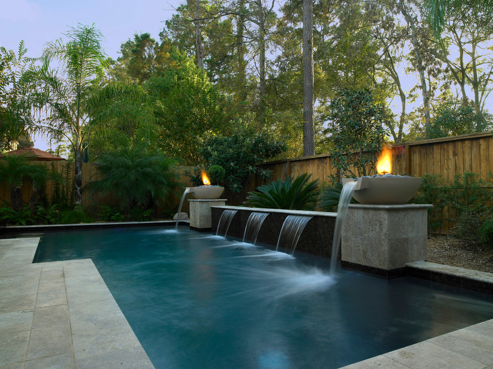 Inspiration for a large contemporary back l-shaped lengths swimming pool in Houston with a water feature and tiled flooring.