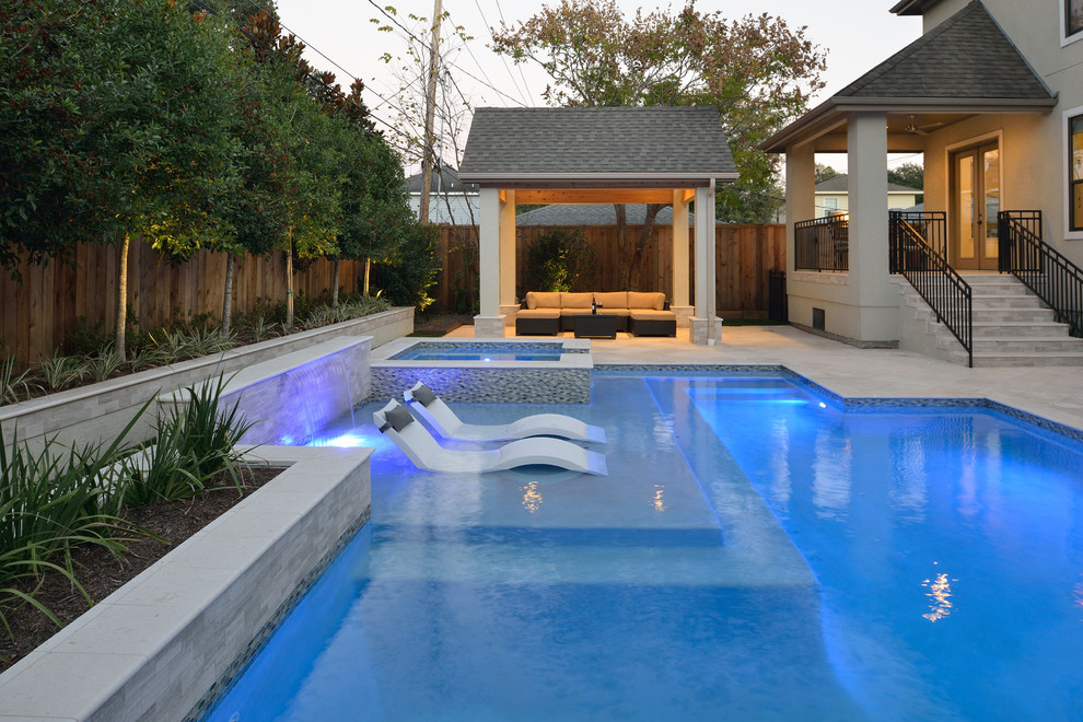 Ispirazione per una piccola piscina naturale design rettangolare dietro casa con una vasca idromassaggio e pavimentazioni in pietra naturale
